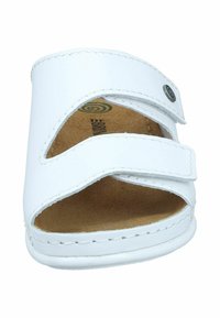 White faux leather sandal with two adjustable Velcro straps, open toe design, and contoured beige footbed. Stitched detailing along edges.