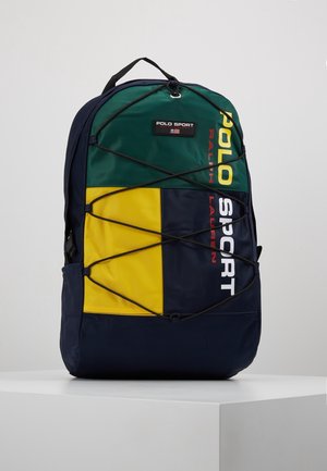 Plecak z zielonymi, żółtymi i granatowymi panelami, czarnym elastycznym sznurkiem z przodu oraz logo Polo Sport Ralph Lauren w żółtych, białych i czerwonych literach.