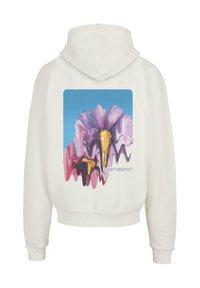 Biela mikina s farebnou grafikou abstraktných kvetov v ružovej a purpurovej farbe, s textom "LOST YOUTH™" na spodnej časti.