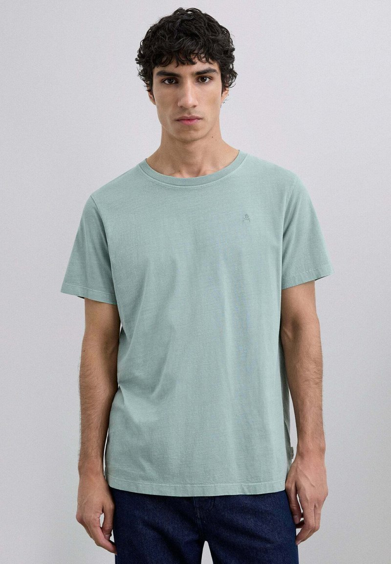 Tricou din bumbac verde mentă deschis, cu decolteu rotund și mâneci scurte, având un mic detaliu logo pe piept. Design simplu și casual.