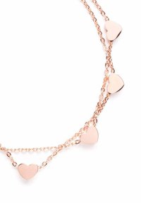 Rose gold necklace featuring five small, polished heart charms on a delicate chain, highlighting a smooth texture and elegant design.