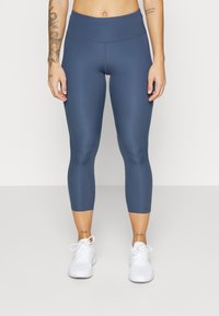 Czarne legginsy capri w wysokim stanie, wykonane z elastycznego materiału, z gładką teksturą i minimalnymi detalami szwów.