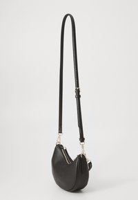 Black leather shoulder bag with a curved shape, featuring a gold zipper and adjustable strap. Textured surface with minimal hardware.