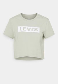 Ljusgrön kortärmad t-shirt i bomull, med en vit rektangulär "LEVI'S"-logotyp på framsidan. Korta ärmar och rund halsringning.