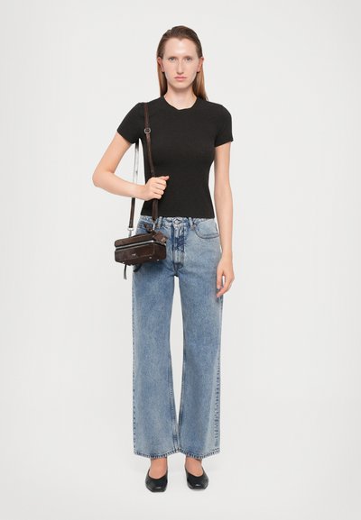 Black fitted t-shirt, high-waisted light blue wide-leg jeans, black flats, and a small brown crossbody bag. Simple, casual outfit.