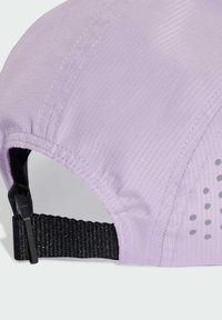 Light purple cap made of textured fabric, featuring a black adjustable strap at the back and grey polka dots on the side.
