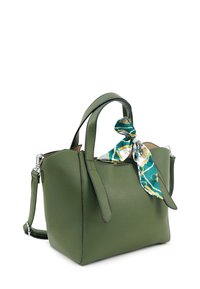 Groene leren handtas met geribbelde textuur, dubbele handvatten, zilveren hardware en een decoratieve blauwe en gouden patroon sjaal geknoopt aan het handvat.