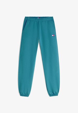 Tyrkisblå joggebukser med elastisk midjebånd og mansjetter, sidelommer og liten rektangulær "Tommy Jeans"-logo på øvre venstre lår.