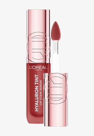 Siero L'Oréal Paris Hyaluron Tint Lip Stain in tubo rosso, con tappo rosa metallico, comprende un applicatore appuntito con punta morbida.