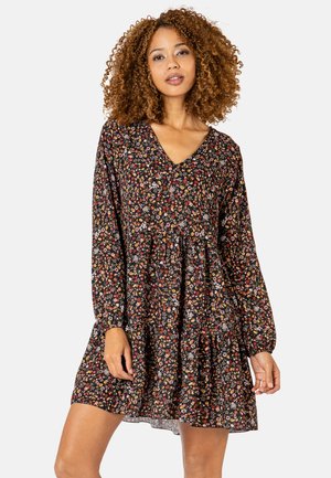 Schwarzes Blumenkleid mit langen Ärmeln, V-Ausschnitt und gestuften Design. Besitzt kleine, farbenfrohe Blumen auf dunklem Hintergrund. Weicher Stofftexture.