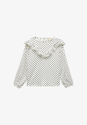 Weiße Bluse mit langen Ärmeln und schwarzen Punkten, ausgestattet mit einem runden Halsauschnitt und einem Rüschendetail entlang des Kragens und der Schultern.