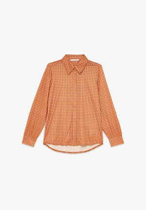 Blusa arancione a maniche lunghe con motivo a pois color viola scuro. Design con colletto, orlo curvo e chiusura frontale con bottoni.