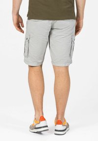 Light gray cargo shorts with two side pockets, rolled hems, and a textured pattern. Worn with multi-colored athletic shoes.