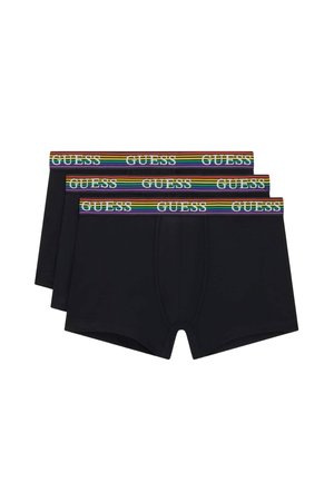 Tres bóxeres negros con cinturilla que llevan la palabra GUESS en blanco y rayas de colores arcoíris.