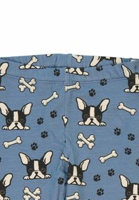 Blå tygleggings med ett mönster av svarta och vita hundhuvuden, vita benknotor och svarta tassavtryck, skapade med en slät textur.