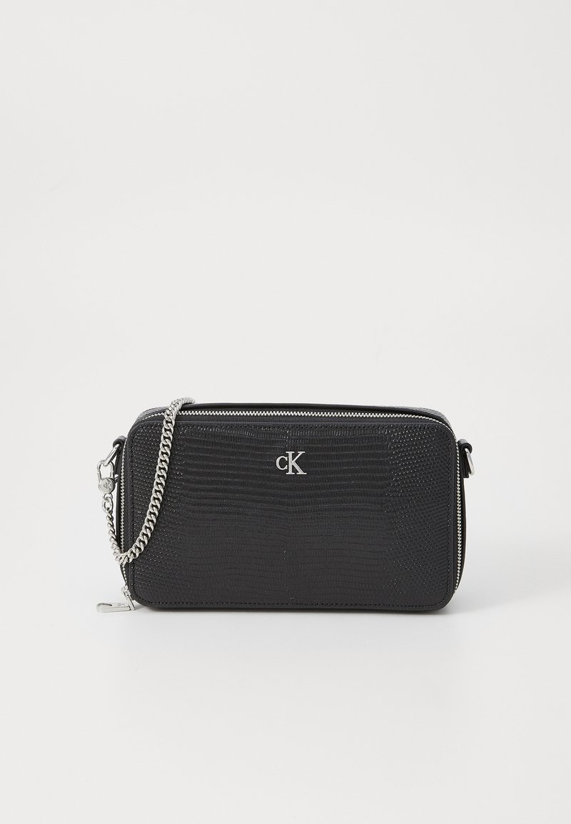 Black textured faux leather clutch with silver hardware, zipper closure, and detachable silver chain strap. Features embossed logo detail.