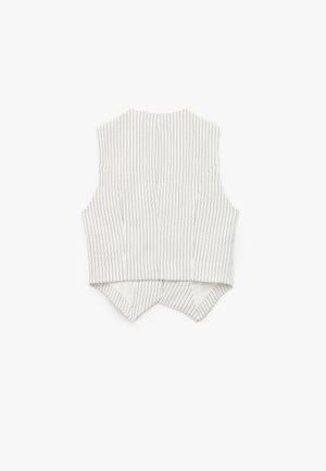 Débardeur blanc sans manches avec des rayures verticales noires, présentant un col haut et un ourlet arrière pointu. Texture de tissu lisse, design ajusté.