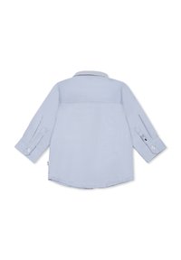 Light blue long-sleeve shirt with a collar, buttoned cuffs, and a yoke detail on the back. Fabric has a smooth texture.