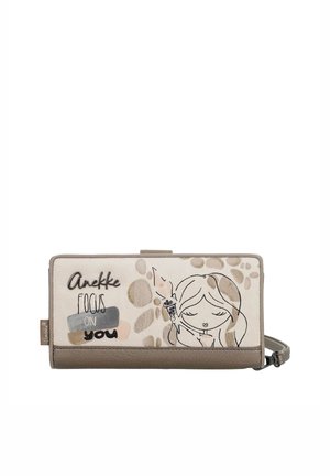 Cartera beige y topo con un dibujo de una niña sosteniendo una bengala y el texto "Anekke Focus on you" en el panel frontal.