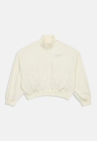 Krémový skrátený sveter s vysokým golierom, polovičným zipsom a jemným šedým logom Nike na ľavej hrudi. Mäkkučká textúra.