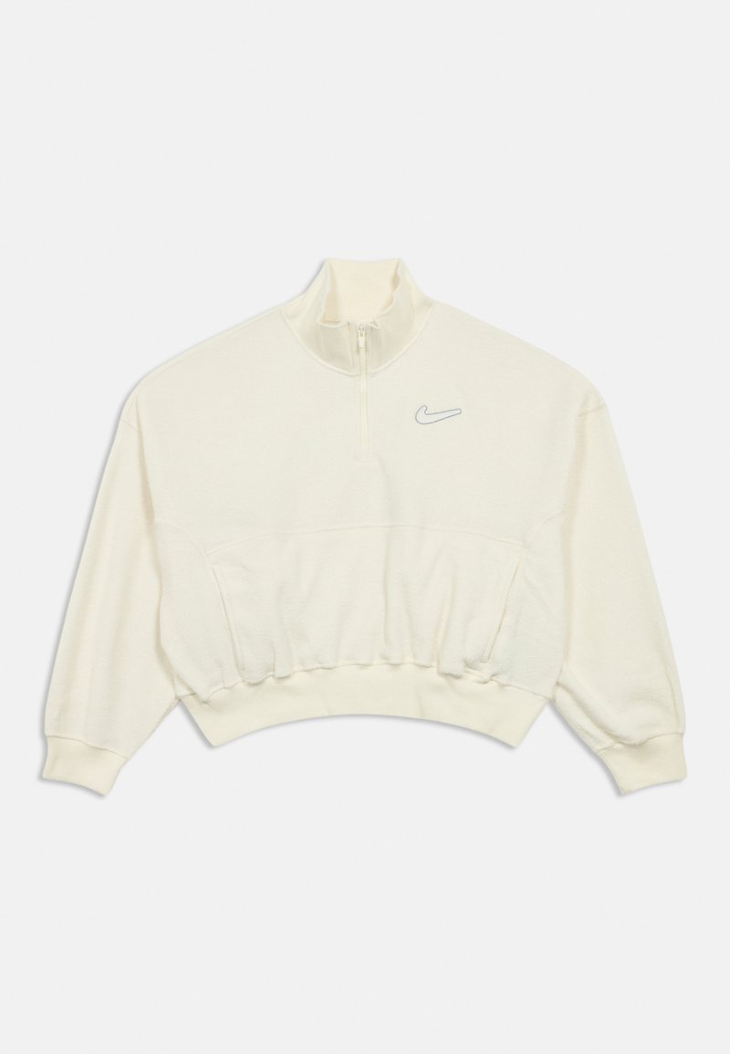 Krémový skrátený sveter s vysokým golierom, polovičným zipsom a jemným šedým logom Nike na ľavej hrudi. Mäkkučká textúra.