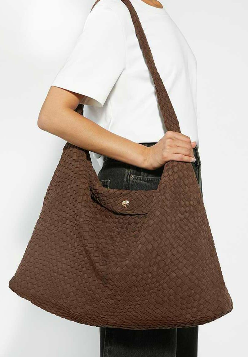 Brown woven shoulder bag with a textured, hobo design. Features a snap closure and a wide, braided strap for easy carrying.