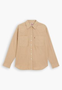 Camicia beige a maniche lunghe con colletto a punta, due tasche sul petto e chiusura frontale con bottoni. Tessuto morbido con una sottile texture.