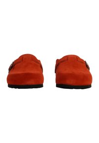 Red suede slip-on shoes with a rounded toe, featuring a brown buckle on each side and a rubber sole. Smooth texture with no visible patterns.