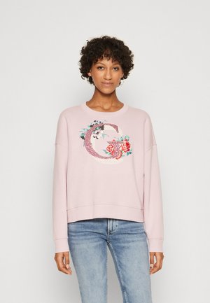 Felpa rosa chiaro con scollatura rotonda e spalle basse, caratterizzata da ricami floreali e dalla lettera "G" in dettagli elaborati.