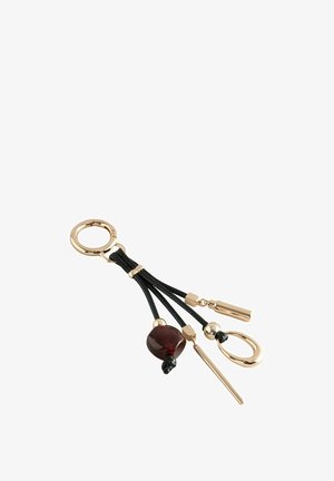 Gold-toned keychain featuring black cord strands with a round maroon bead, tubular and oval accents, and a sleek silver clip.