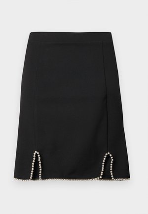 Čierna sukňa s priliehavým strihom a striebornými korálkami zdobiacimi lem, s dekoratívnymi vyrezávanými detailmi na bokoch. Hladká textúra látky.