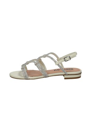 Sandalo donna basso con suola beige, cinturini incrociati decorati con strass e fibbia regolabile alla caviglia.