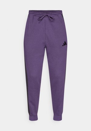 Pantalones deportivos morados con cintura elástica y cordón, con franjas laterales negras y un pequeño logo negro en el muslo izquierdo.