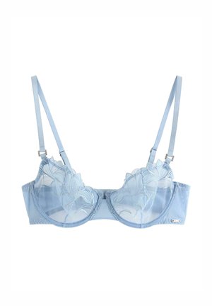 Reggiseno azzurro chiaro trasparente con ricamo floreale, coppe con ferretto e spalline regolabili su sfondo bianco.