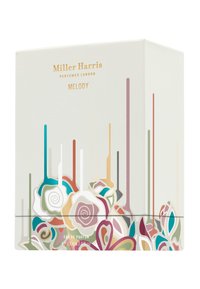 Colorful floral designs adorn a white perfume box labeled "Miller Harris Melody." Gold text highlights the brand and fragrance name.