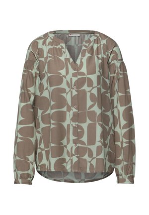 Blouse boutonnée à manches longues avec des formes géométriques abstraites beige et vert clair, et un détail légèrement froncé sur le haut des manches.