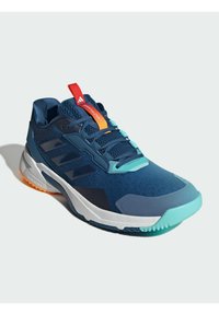 Sininen urheilujalkine, jossa on verkkoyläosa, teksturoituja päällysteitä, kumipohja sekä oransseja ja teal-värisiä yksityiskohtia. Suunnittelussa on näkyvä logo.