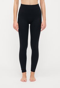 Schwarze Leggings aus dehnbarem Material, mit hohem Bund und einer glatten, untexturierten Oberfläche sowie einer figurbetonten Passform.