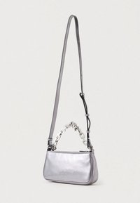 Silver metallic purse with a sleek shape. Features a long strap and a chain handle, smooth texture, and a zip closure.