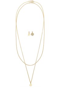 Guldtonad smyckeset med en flerstående halsband som har en fredssymbolhängsmycke och hjärtformade örhängen, utsmyckade med kristaller.