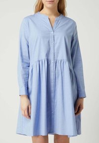 Light blue button-up dress with long sleeves, gathered waist, and a rounded neckline. Made from soft, lightweight fabric.