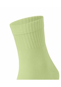 Jasnozielona bawełniana skarpeta z prążkowanym mankietem, gładką fakturą i dopasowanym kształtem. Idealna do noszenia na co dzień lub dla wygody.