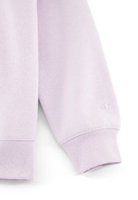 Sudadera de color púrpura claro con puños acanalados y un pequeño logotipo en relieve. La tela tiene un acabado suave y texturizado.