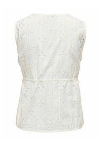 Haut sans manches blanc avec un design en broderie anglaise, présentant des découpes circulaires et une taille froncée pour un look texturé et respirant.