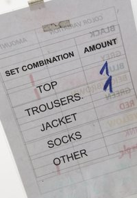 Clothing order form listing set combinations: top, trousers, jacket, socks, other, with handwritten numbers "1" and "2" in the amount column.