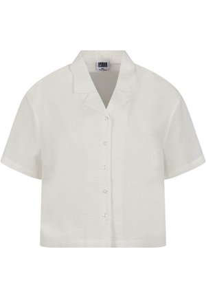 Camisa blanca de manga corta y cuello, fabricada en un tejido texturizado con cierre de botones en la parte delantera. Cuenta con botones transparentes y un diseño de corte relajado.