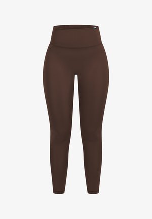 Nahtlose, braune Sportleggings mit hohem Bund und kleinem Logotag am Taillenbund, entwickelt für Dehnbarkeit und Komfort.