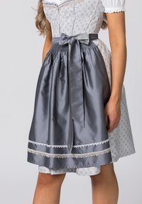 Gray satin apron with a tied bow, white lace trim at the hem, worn over a patterned dress with a fitted bodice and short puffed sleeves.