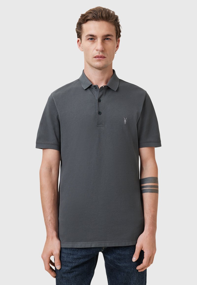 Dunkelgraues Poloshirt aus Baumwolle mit einem Kragen, einer Drei-Knopf-Leiste und einem kleinen gestickten Logo auf der Brust. Kurzärmlig.