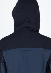 Navy blue jacket with a hood, featuring a two-tone design and logo on the back. Made of weather-resistant material with a smooth texture.